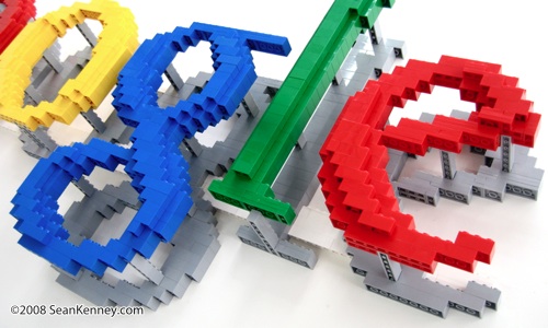 Wall-mounted sculpture of company logo, built with LEGO bricks